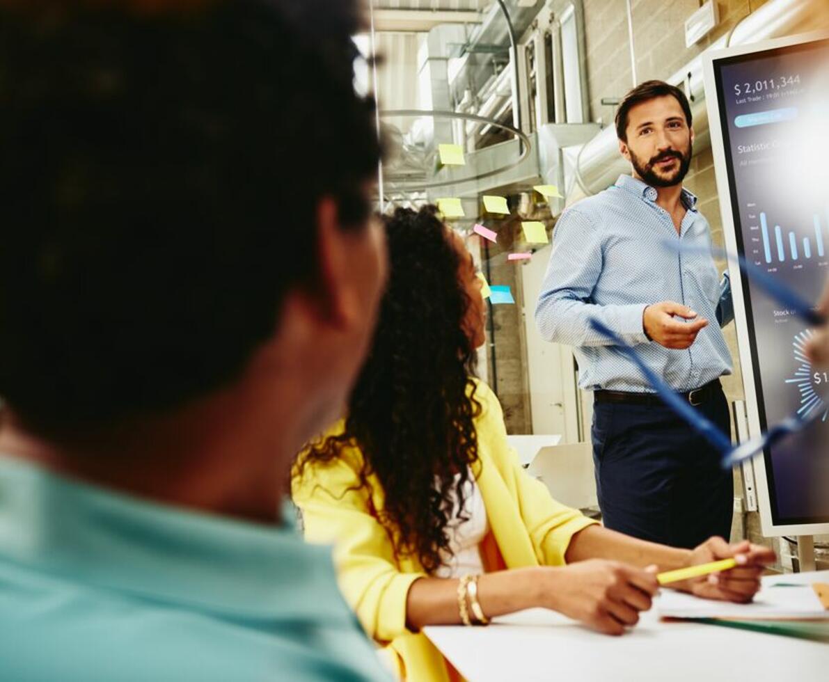 Three colleagues having a meeting in a meeting room.