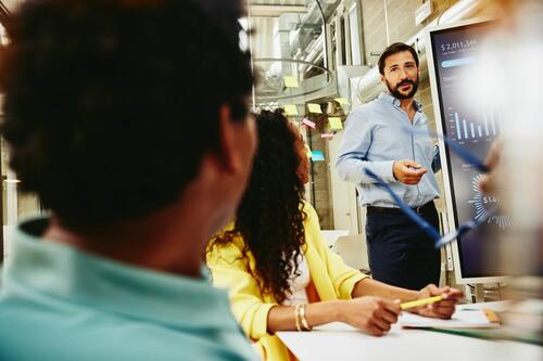 Three colleagues having a meeting in a meeting room.