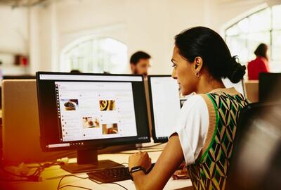 Woman sitting at a desk working on marketing platform.