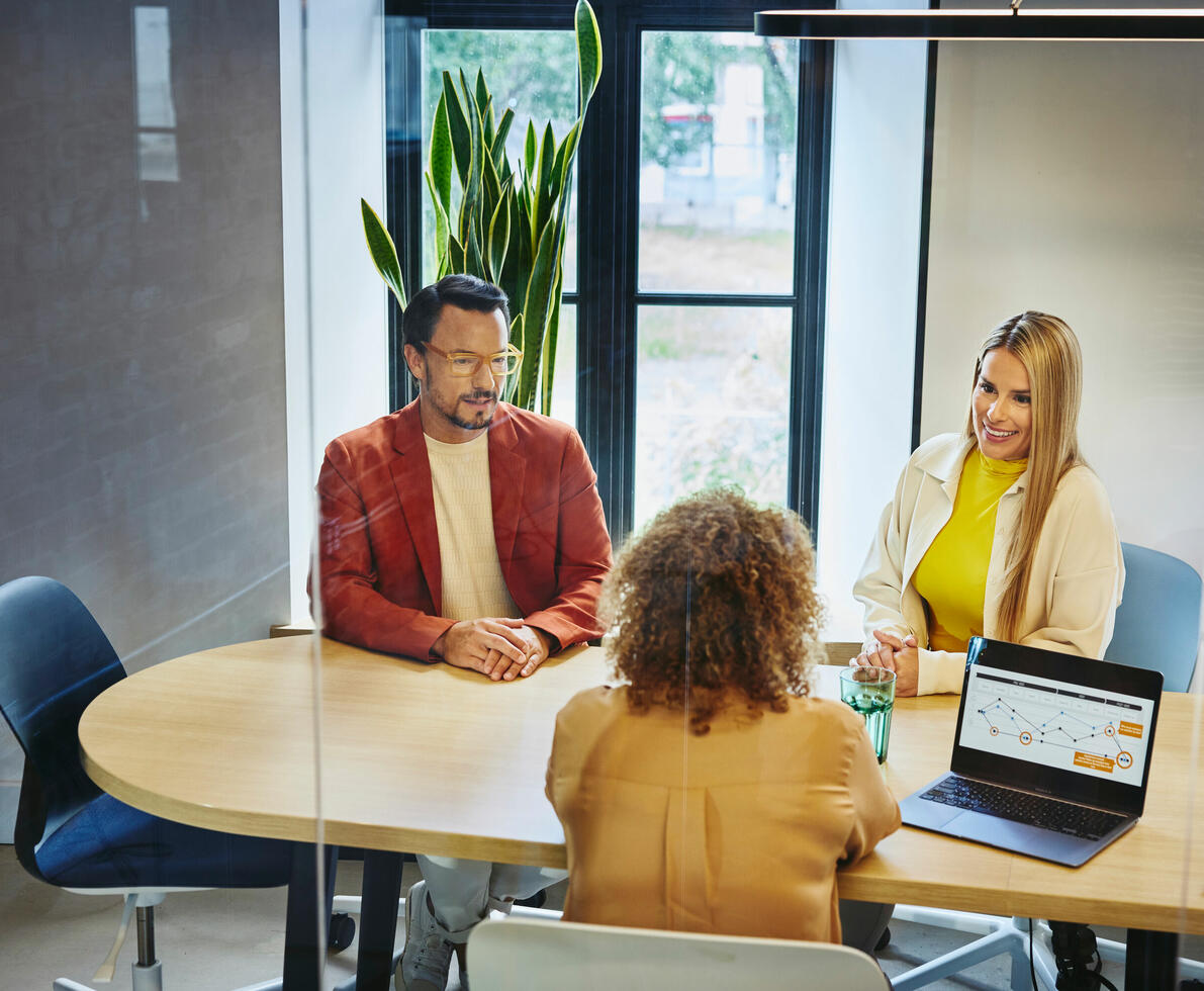Three people in a meeting