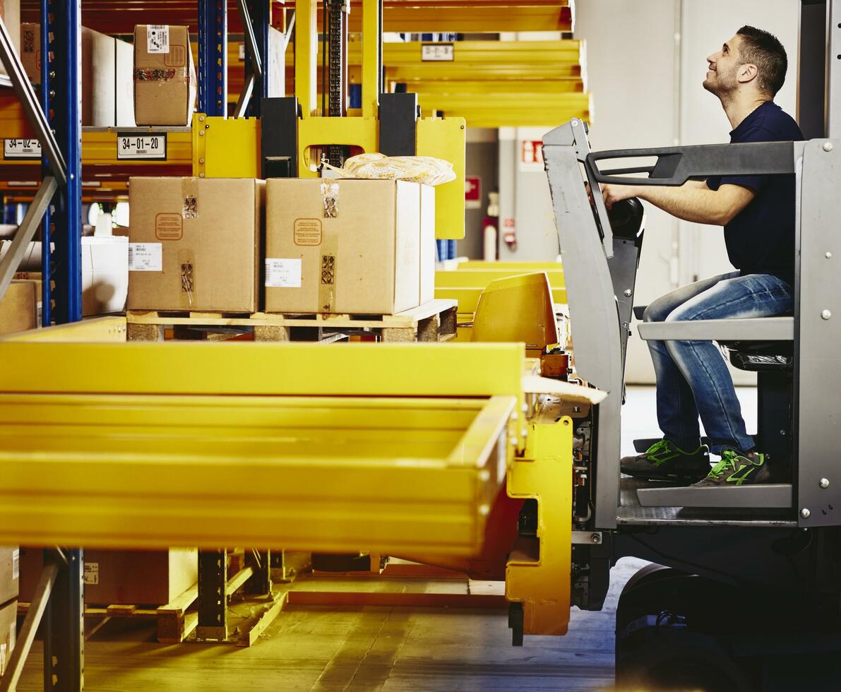 Man operating a forklift with boxes.
