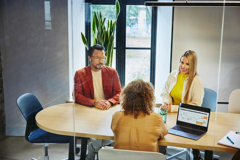 Three people in a meeting